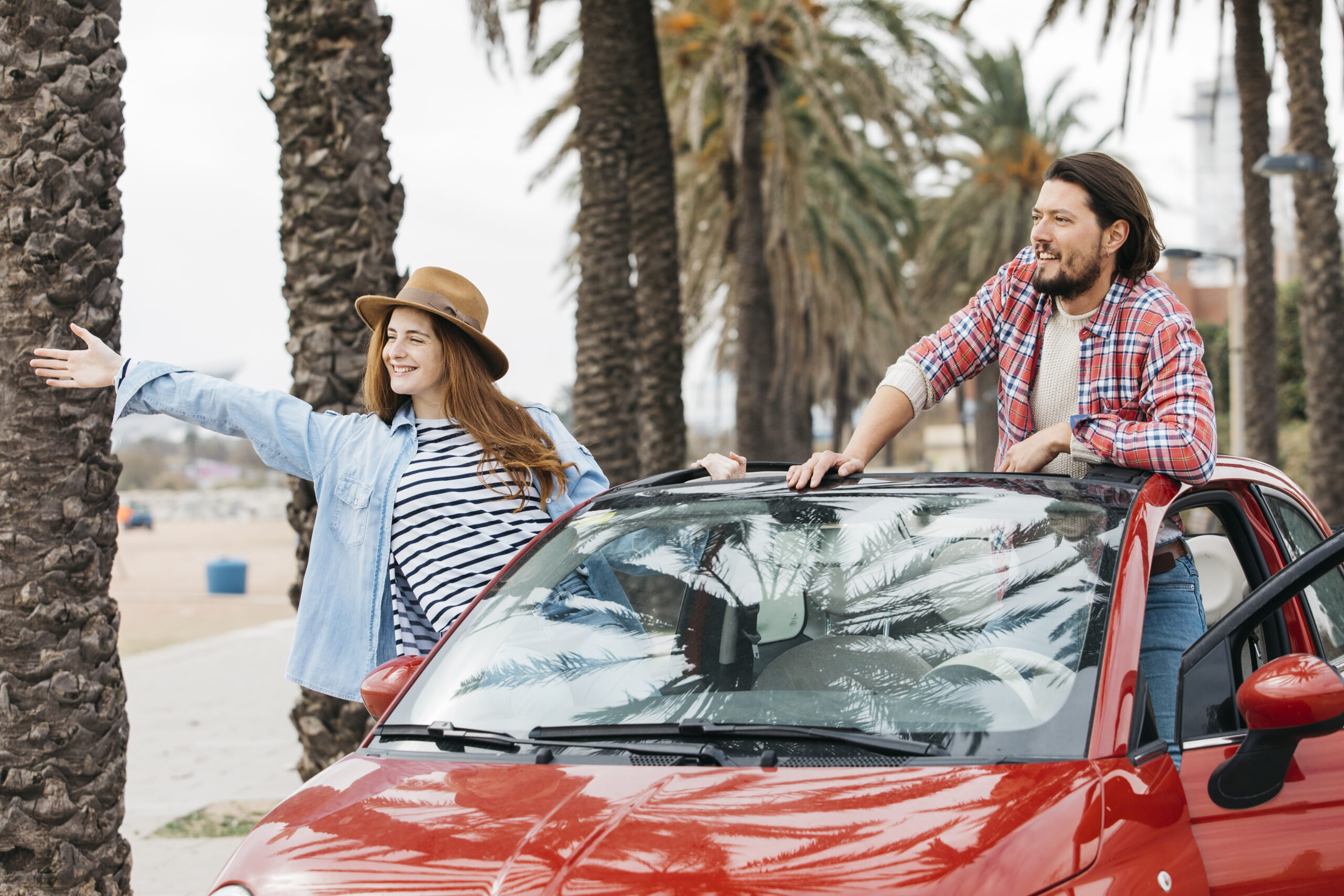 young-cheerful-woman-man-leaning-out-from-car